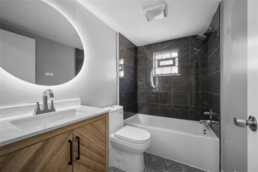 3943 Howley Street Pittsburgh, PA 15224 - Photo 16 of 32 a bathroom with a sink a toilet and shower