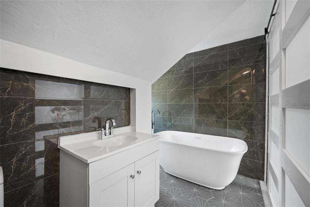 3943 Howley Street Pittsburgh, PA 15224 - Photo 21 of 32 a bathroom with a sink and mirror