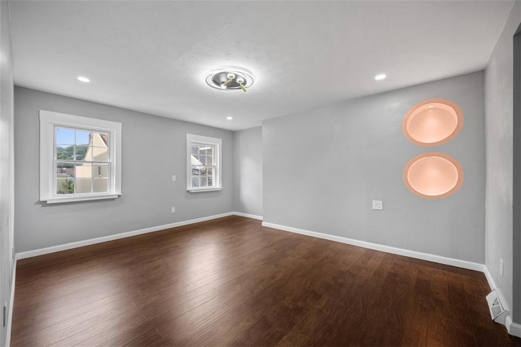 3943 Howley Street Pittsburgh, PA 15224 - Photo 10 of 32 an empty room with wooden floor and windows