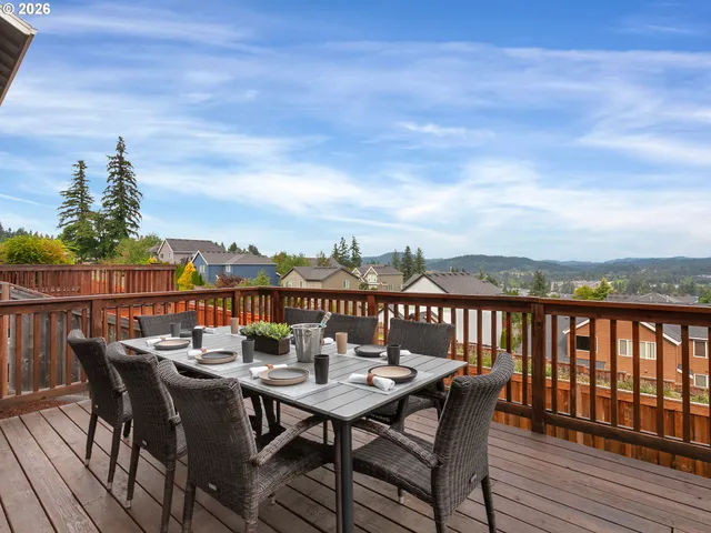 a view of a city from a balcony with furniture