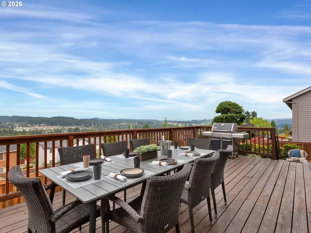 a view of a dining table and chairs on the roof deck