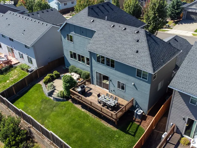 an aerial view of a house with a yard