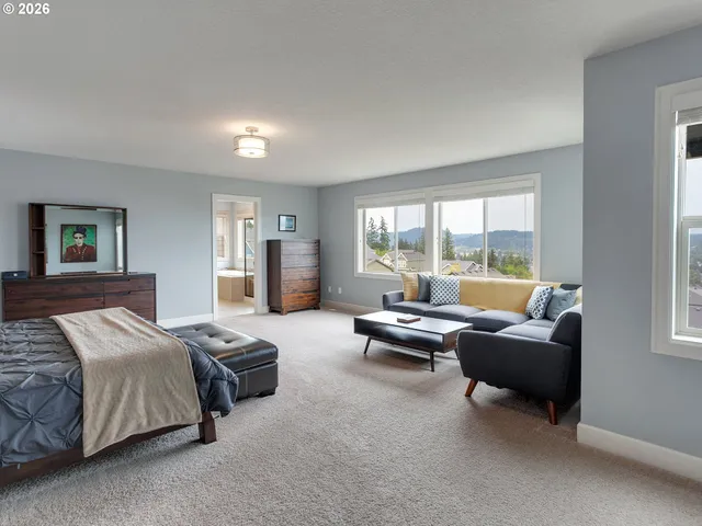 a bedroom with bed couch and window