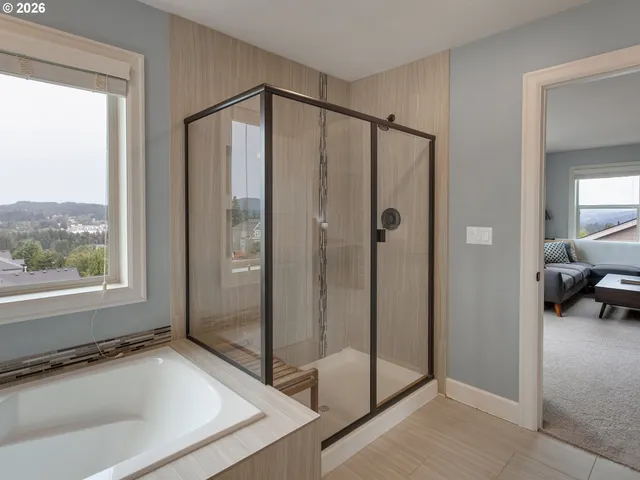 a bathroom with a tub and a shower