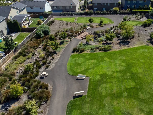 an aerial view of a house with a yard and outdoor seating