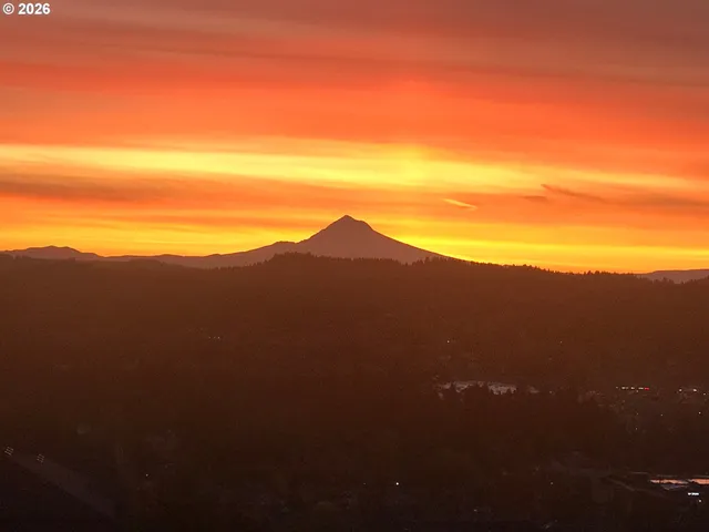 a view of a mountain range with a cloudy sky