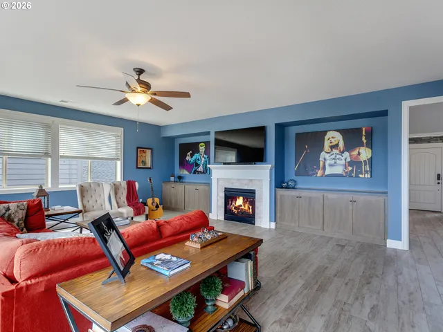a living room with furniture a flat screen tv and a fireplace