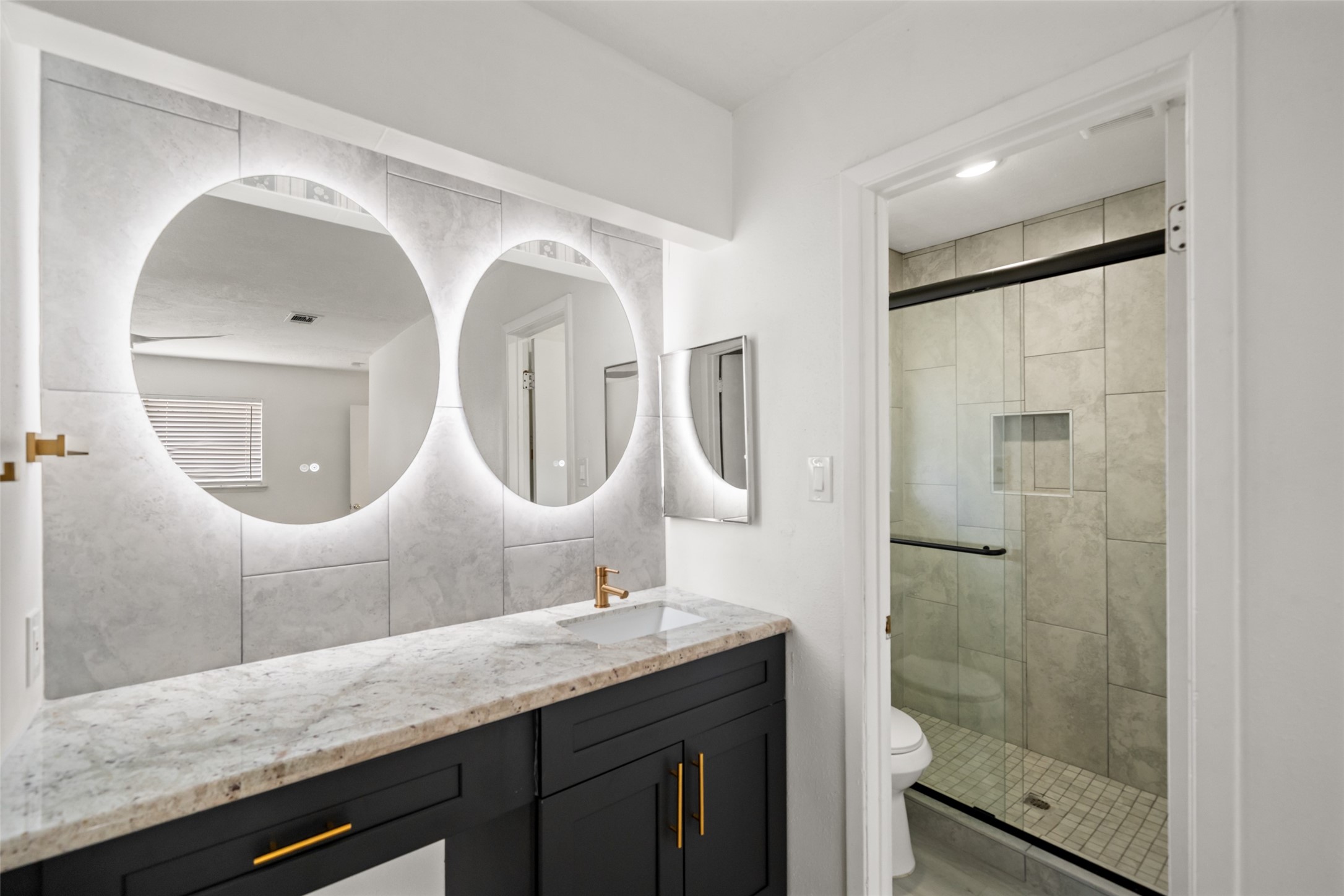5726 Yorkgate Drive Spring, TX 77373 - Photo 14 of 20 a bathroom with a double vanity sink and a mirror