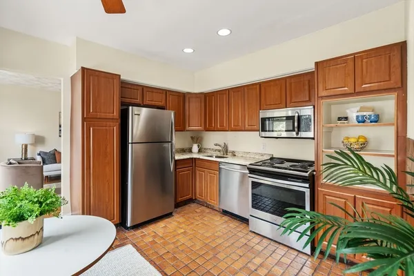 a kitchen with stainless steel appliances granite countertop a refrigerator stove and microwave