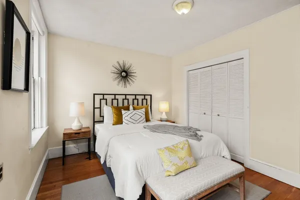 a bedroom with a bed and a window