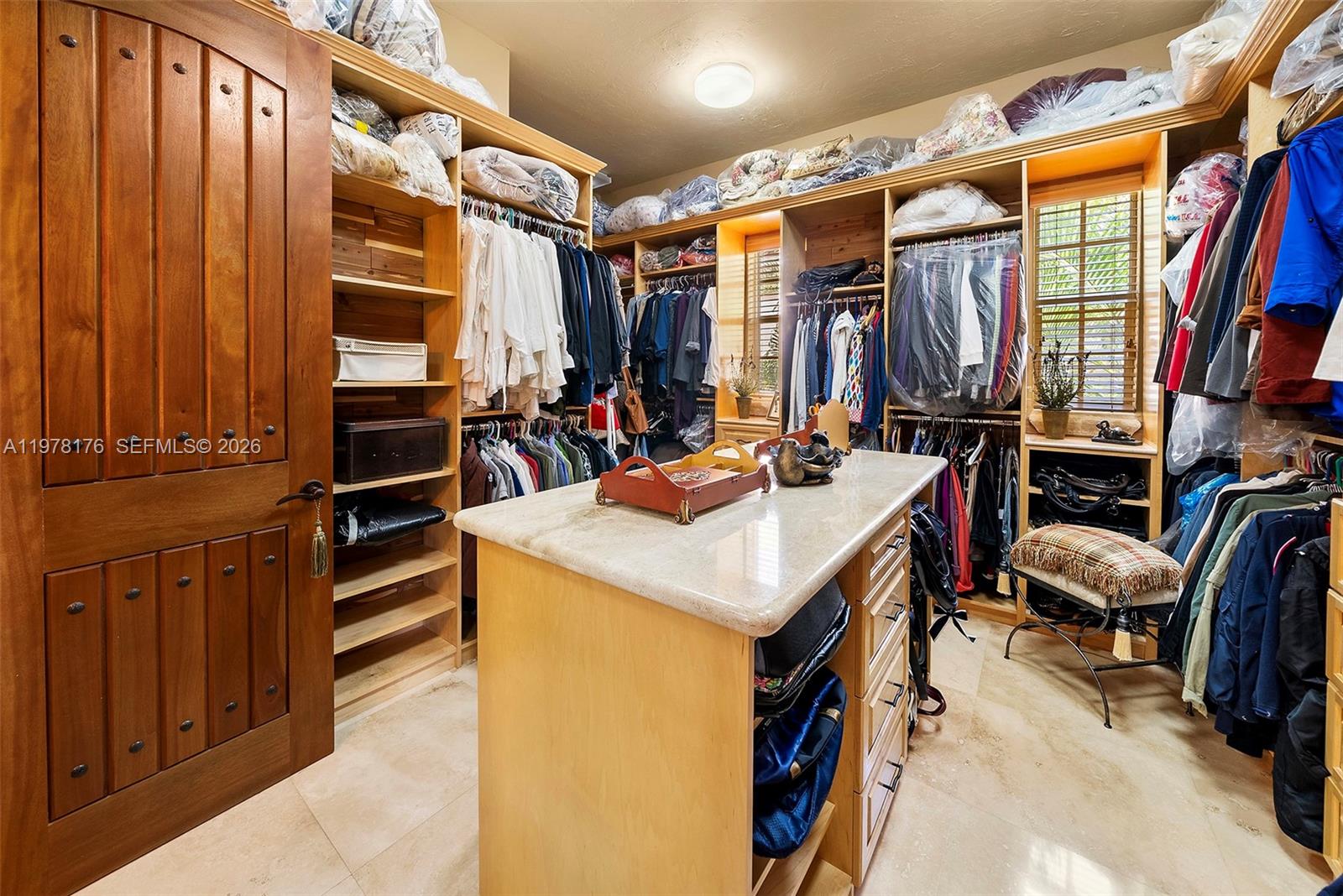 4501 North Bay Road Miami Beach, FL 33140 - Photo 13 of 24 a view of walk in closet with clothes and shoes