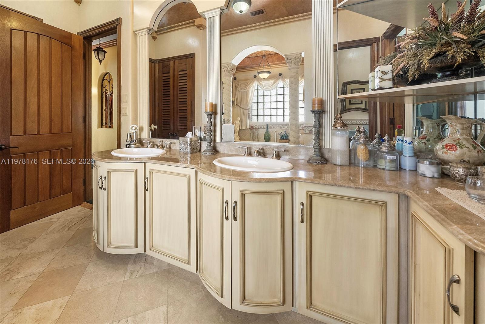 4501 North Bay Road Miami Beach, FL 33140 - Photo 16 of 24 a bathroom with a sink a vanity and a mirror