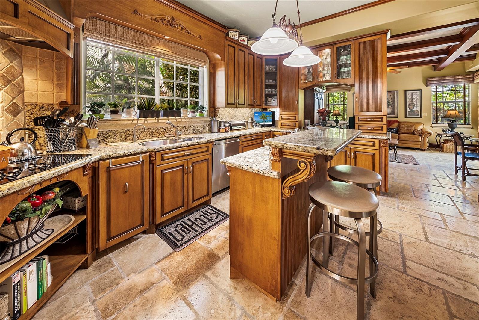 4501 North Bay Road Miami Beach, FL 33140 - Photo 6 of 24 a kitchen with stainless steel appliances granite countertop a sink and cabinets