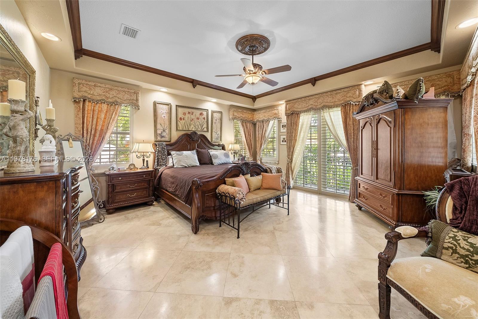 4501 North Bay Road Miami Beach, FL 33140 - Photo 9 of 24 a spacious bedroom with a bed couch and a large window