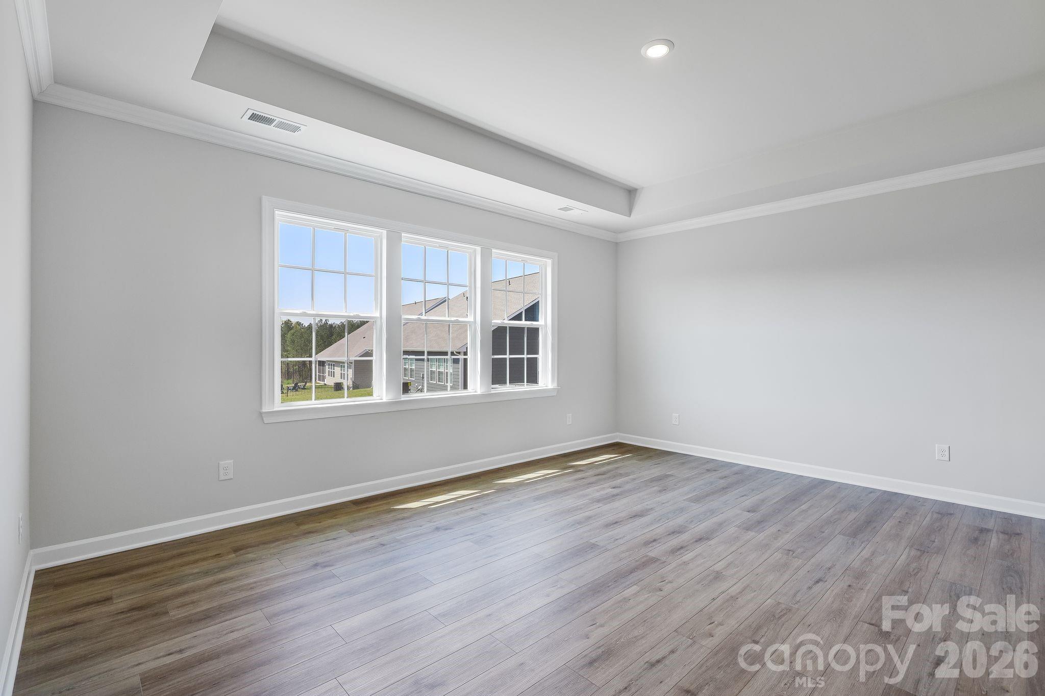 2287 Moon Crst Road, Unit 143 Lancaster, SC 29720 - Photo 11 of 35 an empty room with wooden floor and windows