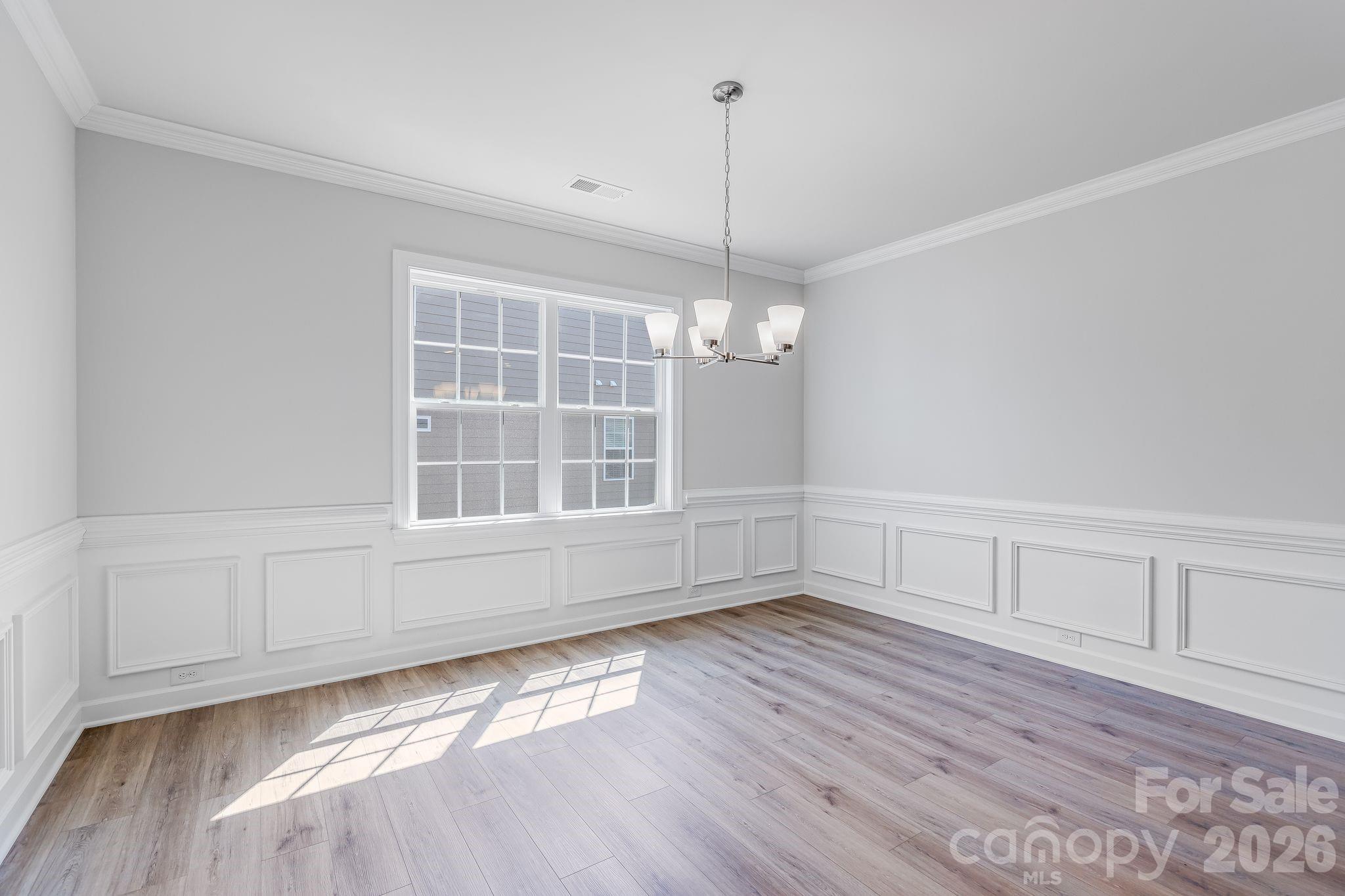 2287 Moon Crst Road, Unit 143 Lancaster, SC 29720 - Photo 23 of 35 a view of an empty room with wooden floor fridge and a window