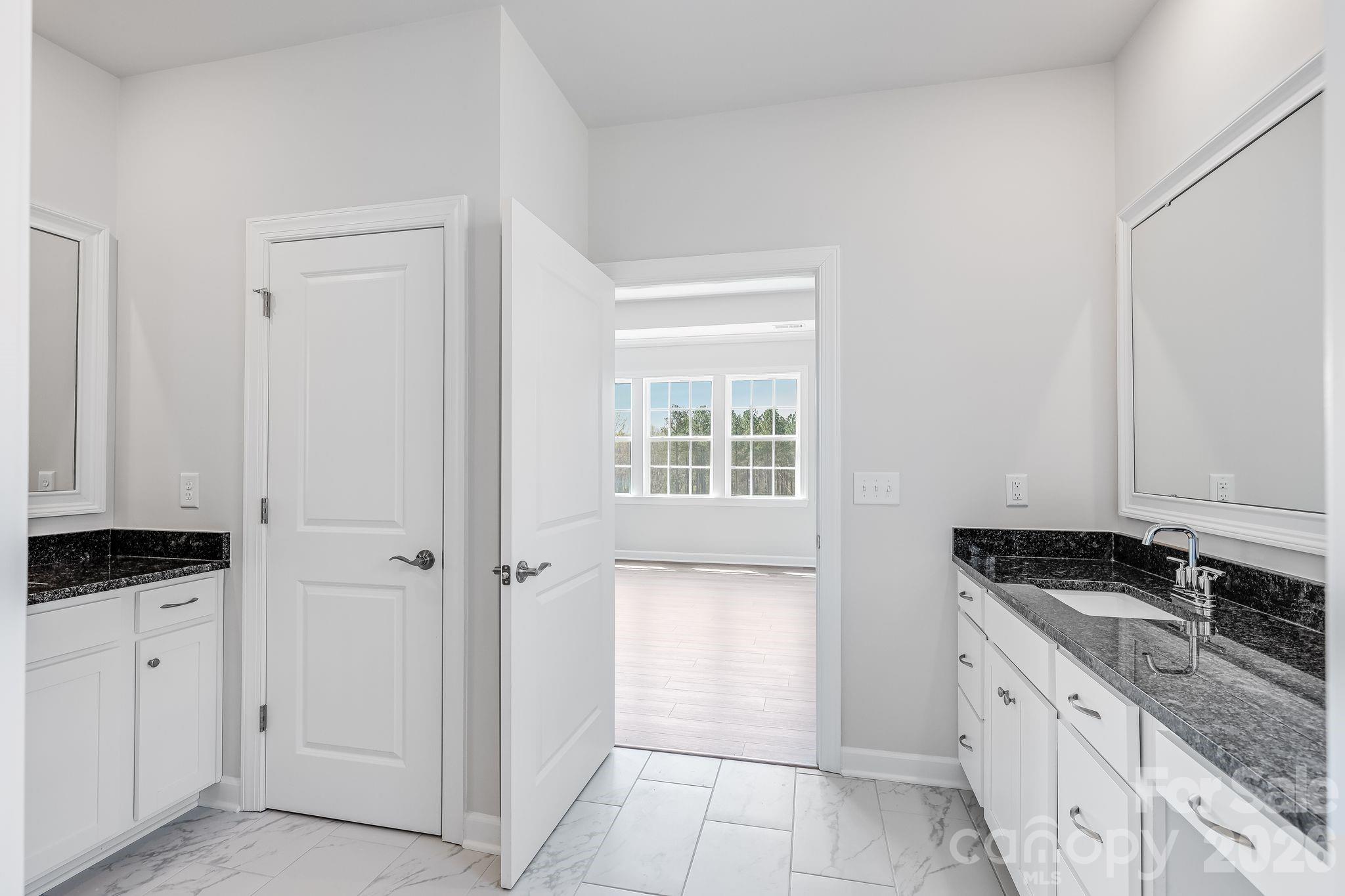 2287 Moon Crst Road, Unit 143 Lancaster, SC 29720 - Photo 25 of 35 a kitchen with granite countertop a sink and a stove