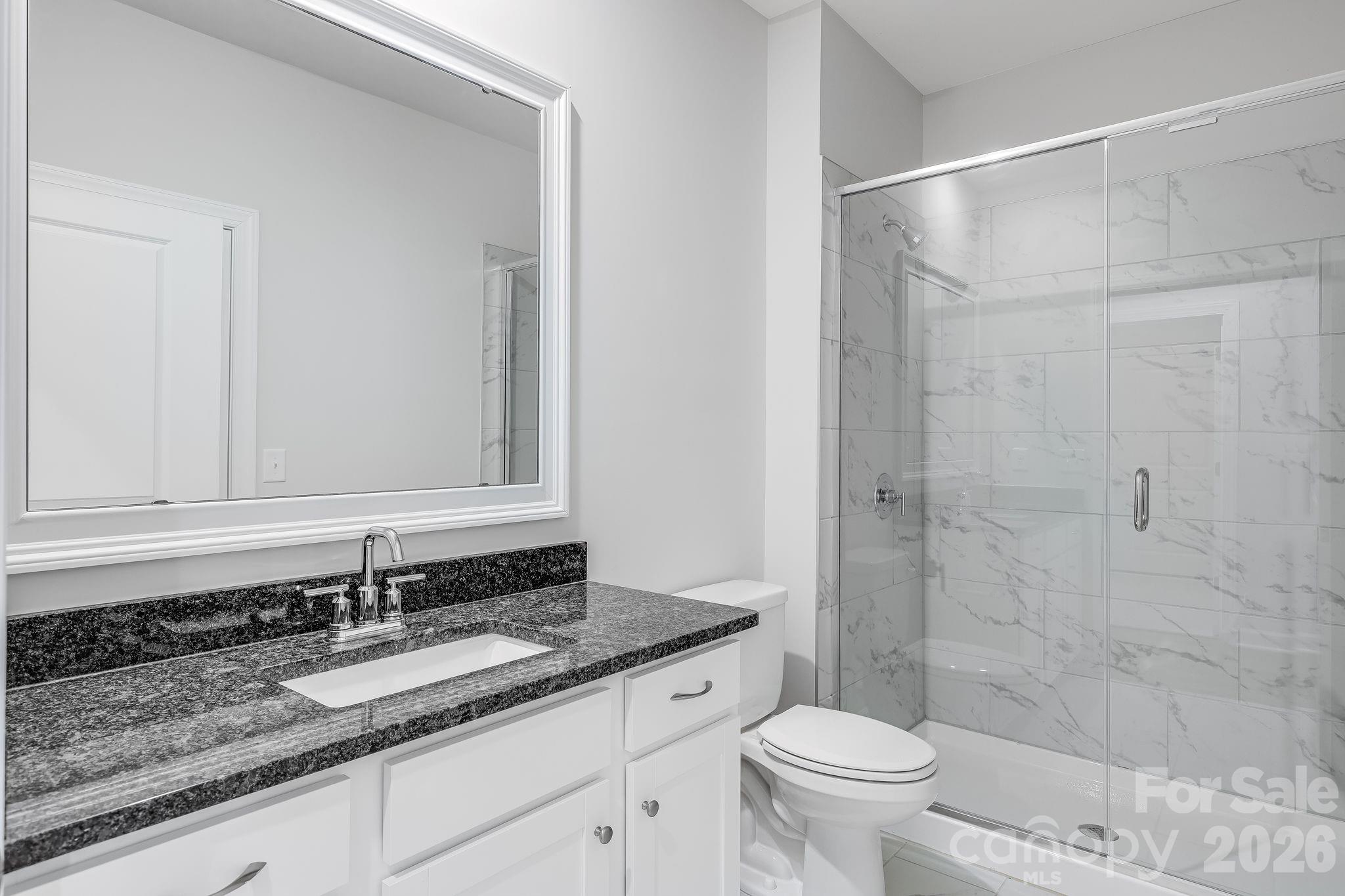 2287 Moon Crst Road, Unit 143 Lancaster, SC 29720 - Photo 29 of 35 a bathroom with a granite countertop sink toilet and shower