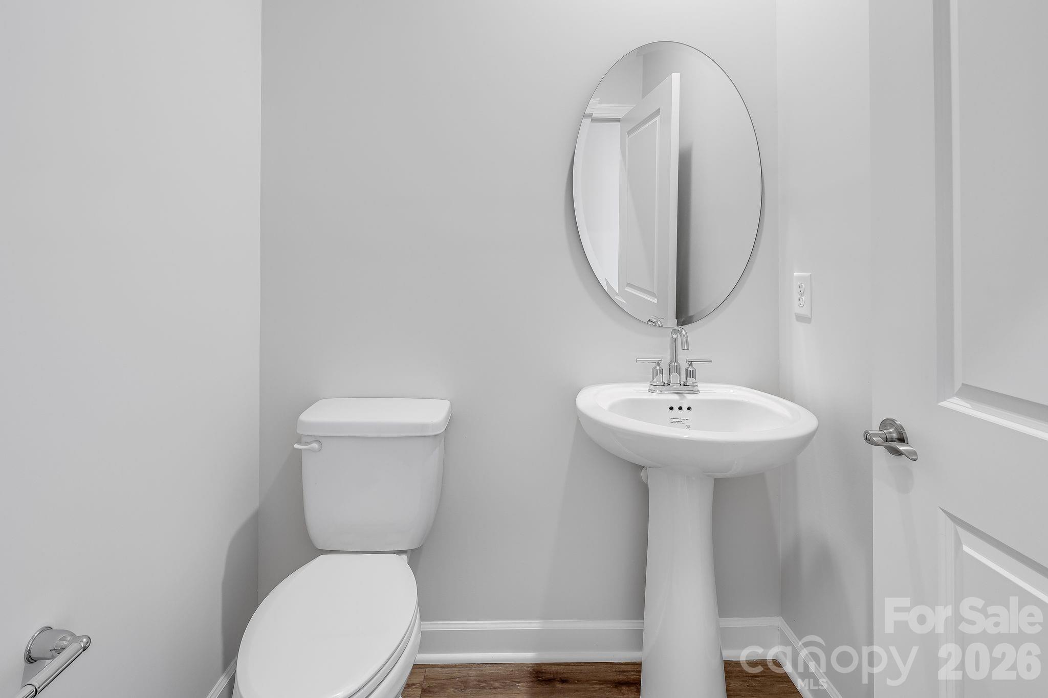 2287 Moon Crst Road, Unit 143 Lancaster, SC 29720 - Photo 30 of 35 a bathroom with a toilet a sink and a mirror