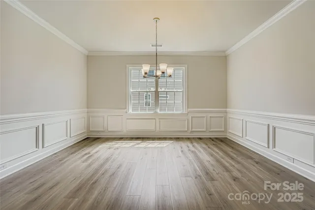 a kitchen with stainless steel appliances a stove top oven and a refrigerator