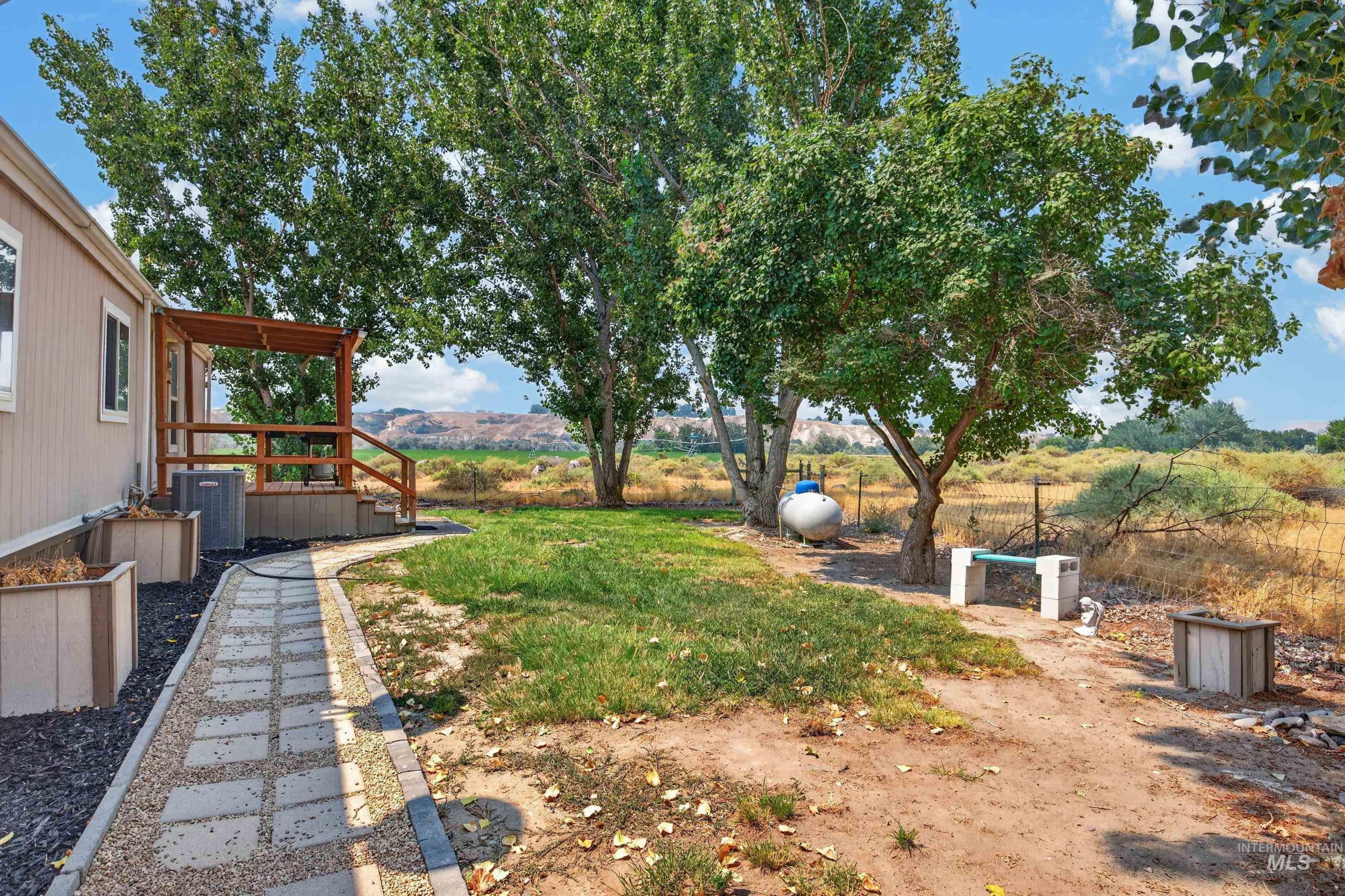7417 Map Rock Road Caldwell, ID 83607 - Photo 10 of 32 Covered deck featuring wood railing and steps