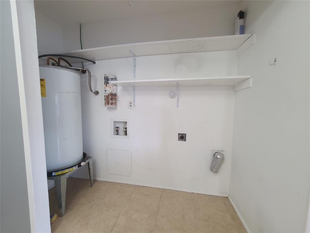 5644 Perrin Street The Colony, TX 75056 - Photo 7 of 16 Clothes washing area with electric dryer hookup, electric water heater, light tile patterned floors, and washer hookup