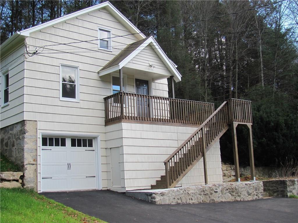 a view of house with backyard and trees