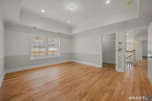 a view of a room with wooden floor