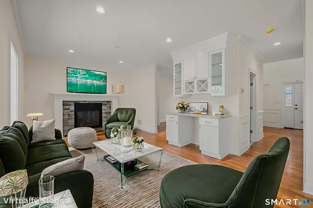 a living room with furniture and a fireplace