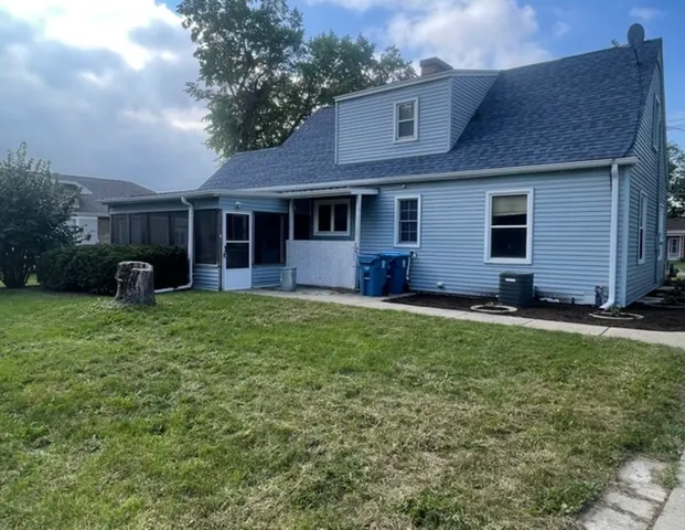 a view of a house with backyard and porch