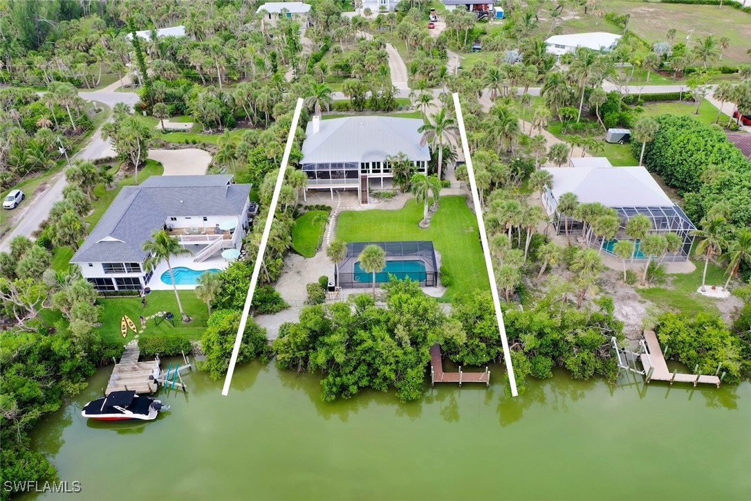 an aerial view of a house with a garden and lake view