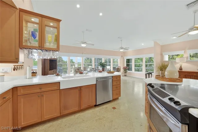 a kitchen with stainless steel appliances granite countertop a sink and cabinets