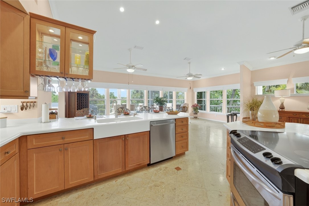6120 Henderson Road Sanibel, FL 33957 - Photo 14 of 50 a kitchen with stainless steel appliances granite countertop a sink and cabinets