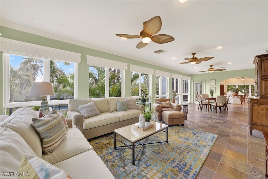 6120 Henderson Road Sanibel, FL 33957 - Photo 16 of 50 a living room with furniture ceiling fan and a large window