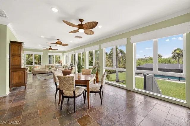 a dining room with furniture a chandelier and a rug