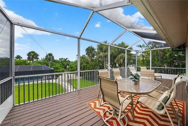 a view of a patio with a table chairs and a backyard