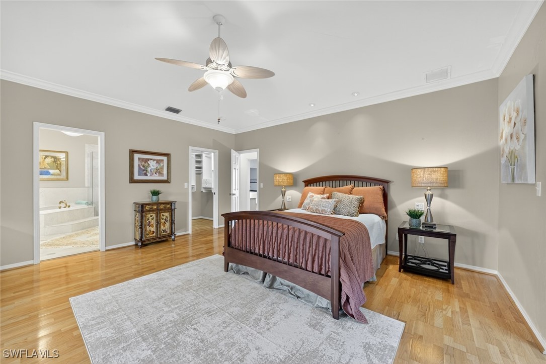 6120 Henderson Road Sanibel, FL 33957 - Photo 23 of 50 a spacious bedroom with a bed and a chandelier