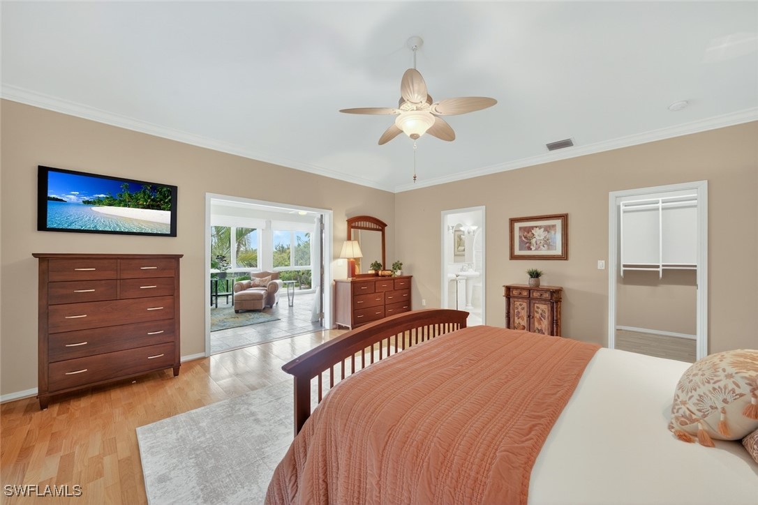 6120 Henderson Road Sanibel, FL 33957 - Photo 24 of 50 a bedroom with a bed and a dresser