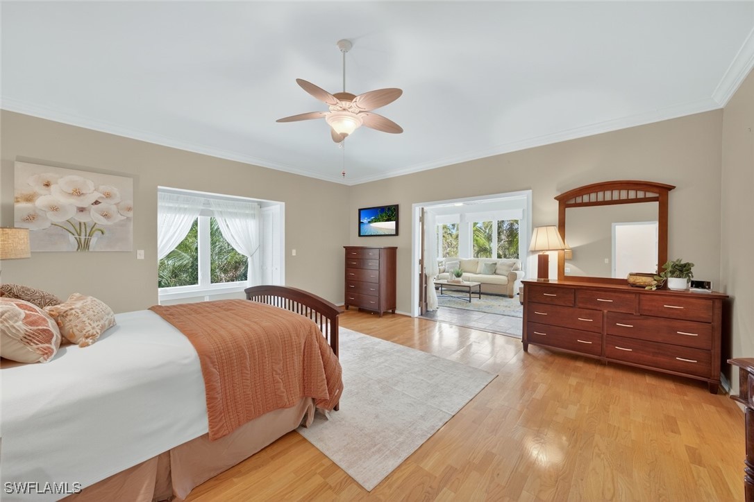 6120 Henderson Road Sanibel, FL 33957 - Photo 25 of 50 a bed room with a bed and a dresser