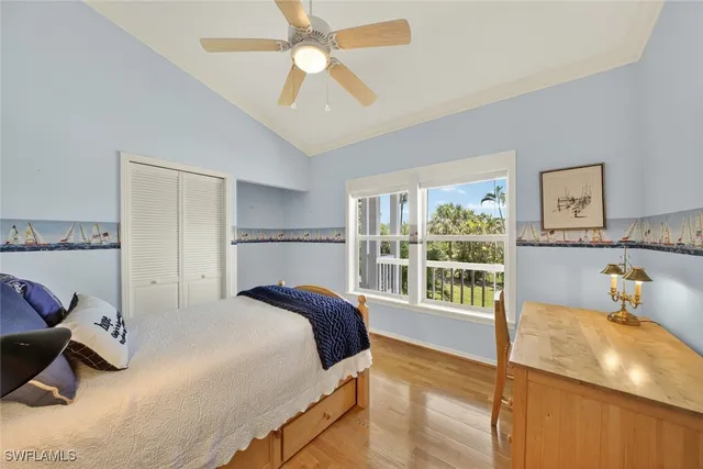a bedroom with a large bed and a large window
