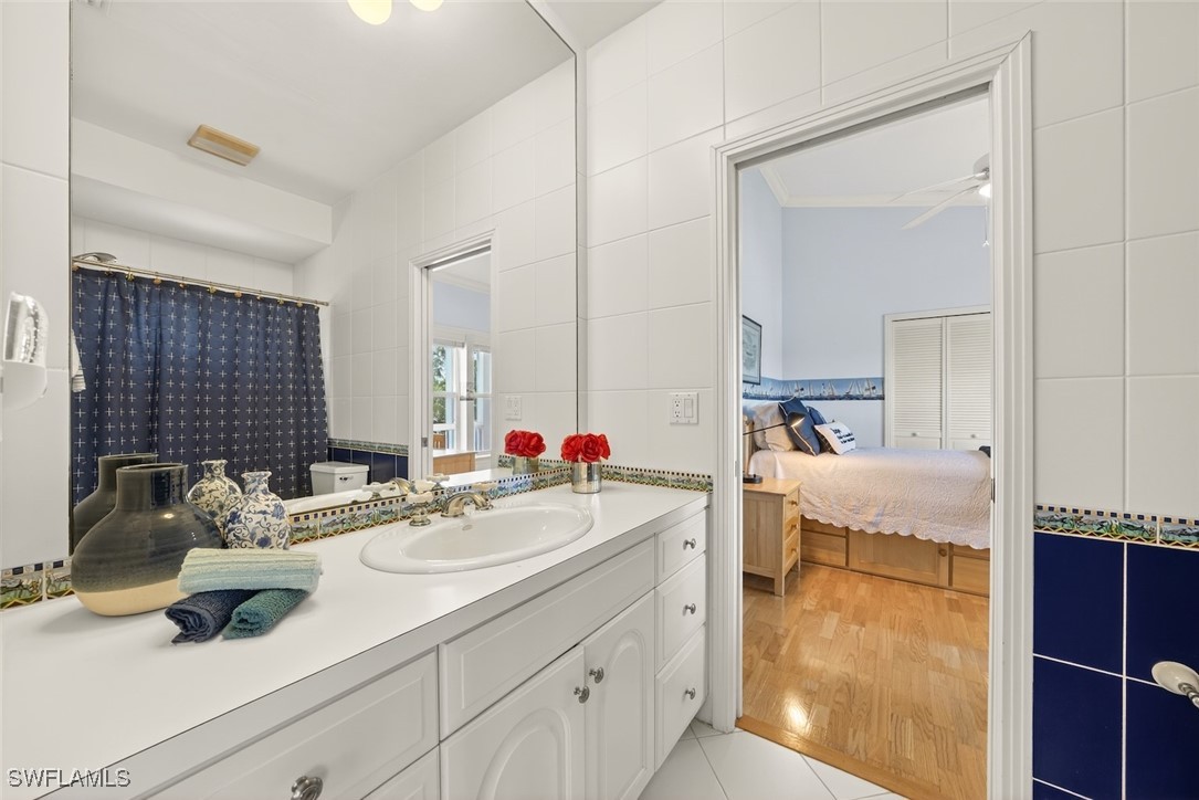 6120 Henderson Road Sanibel, FL 33957 - Photo 32 of 50 a en suite bathroom with a sink and a mirror