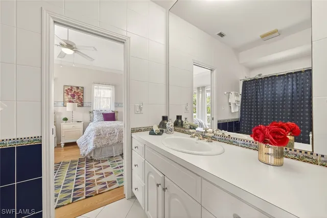 a bathroom with a sink vanity granite and a mirror
