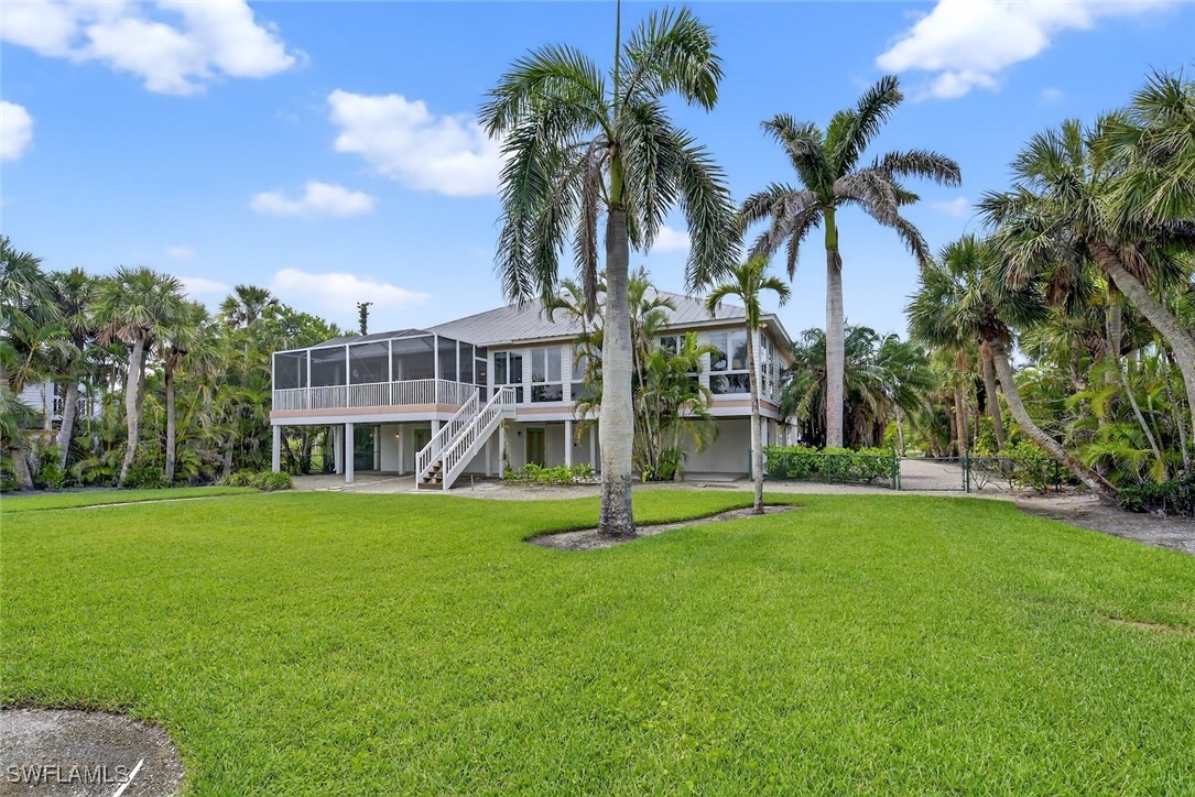 6120 Henderson Road Sanibel, FL 33957 - Photo 36 of 50 a house with palm tree in the background