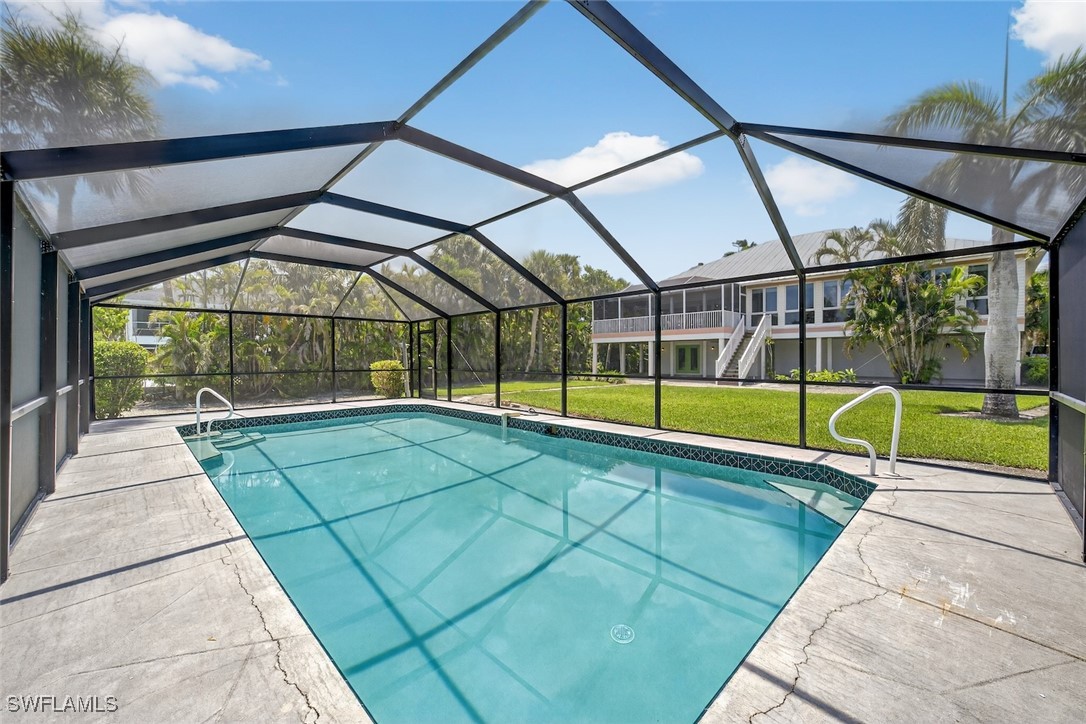 6120 Henderson Road Sanibel, FL 33957 - Photo 40 of 50 a view of a backyard with a swimming pool