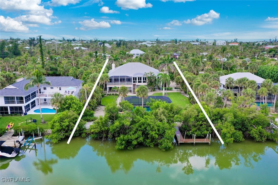 6120 Henderson Road Sanibel, FL 33957 - Photo 45 of 50 a aerial view of a house with swimming pool patio and lake view