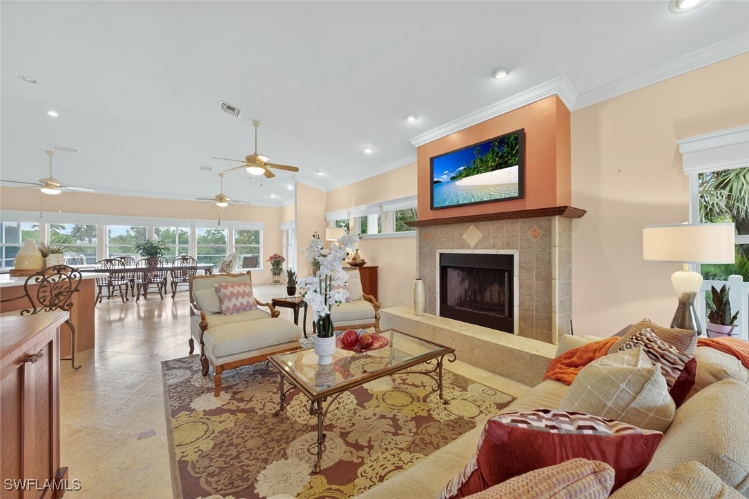 6120 Henderson Road Sanibel, FL 33957 - Photo 6 of 50 a living room with furniture a table and a fireplace