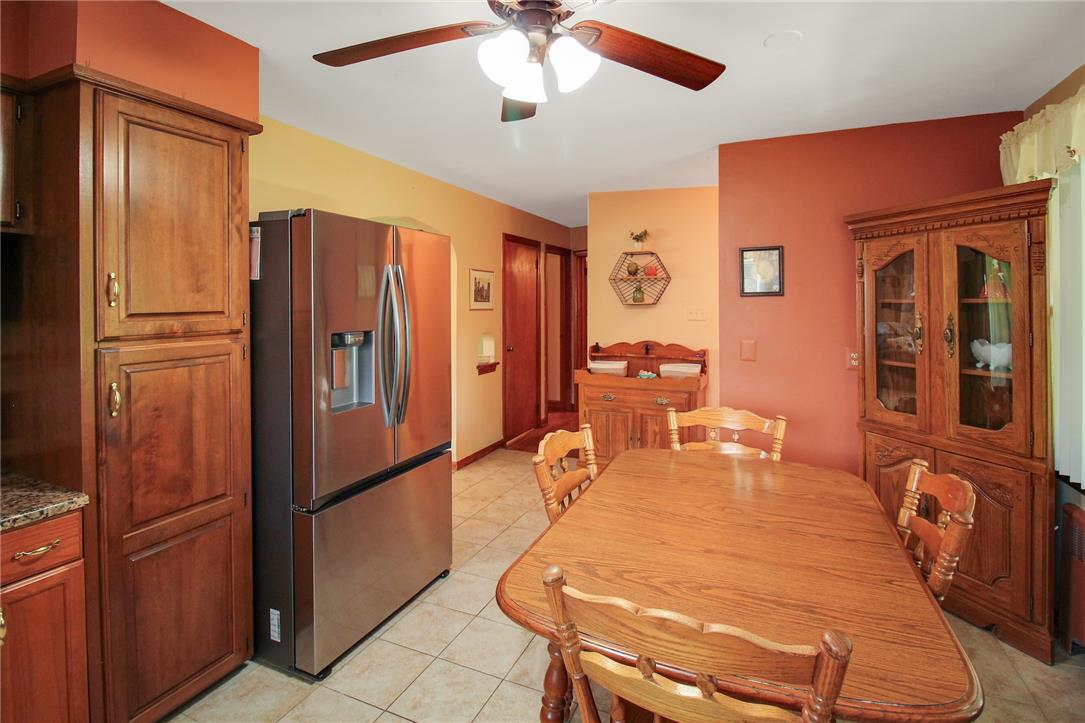1256 Ridge Avenue Whitehall, PA 18052 - Photo 22 of 43 A classic dining area with warm hues, featuring a ceiling fan and a tile floor.