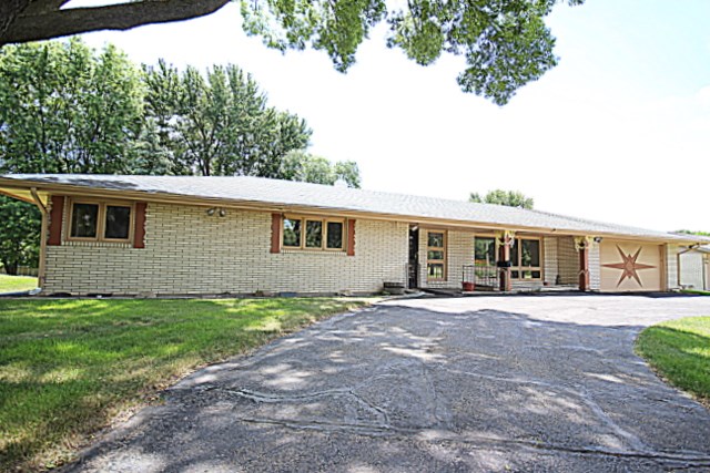6929 Spring Brook Road Rockford, IL 61114 - Photo 1 of 17 a front view of a house with a garden