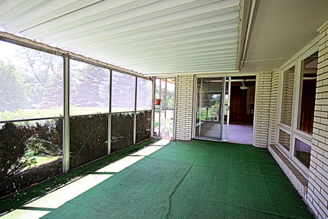 6929 Spring Brook Road Rockford, IL 61114 - Photo 16 of 17 a view of a porch with a floor to ceiling window and wooden floor