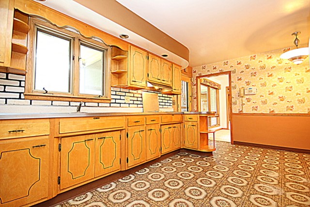6929 Spring Brook Road Rockford, IL 61114 - Photo 7 of 17 a view of a kitchen with stainless steel appliances granite countertop cabinets and a large window